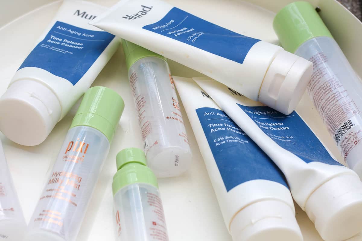 Murad Time Release Acne Cleanser and Pixi Hydrating Milky Mist empties.